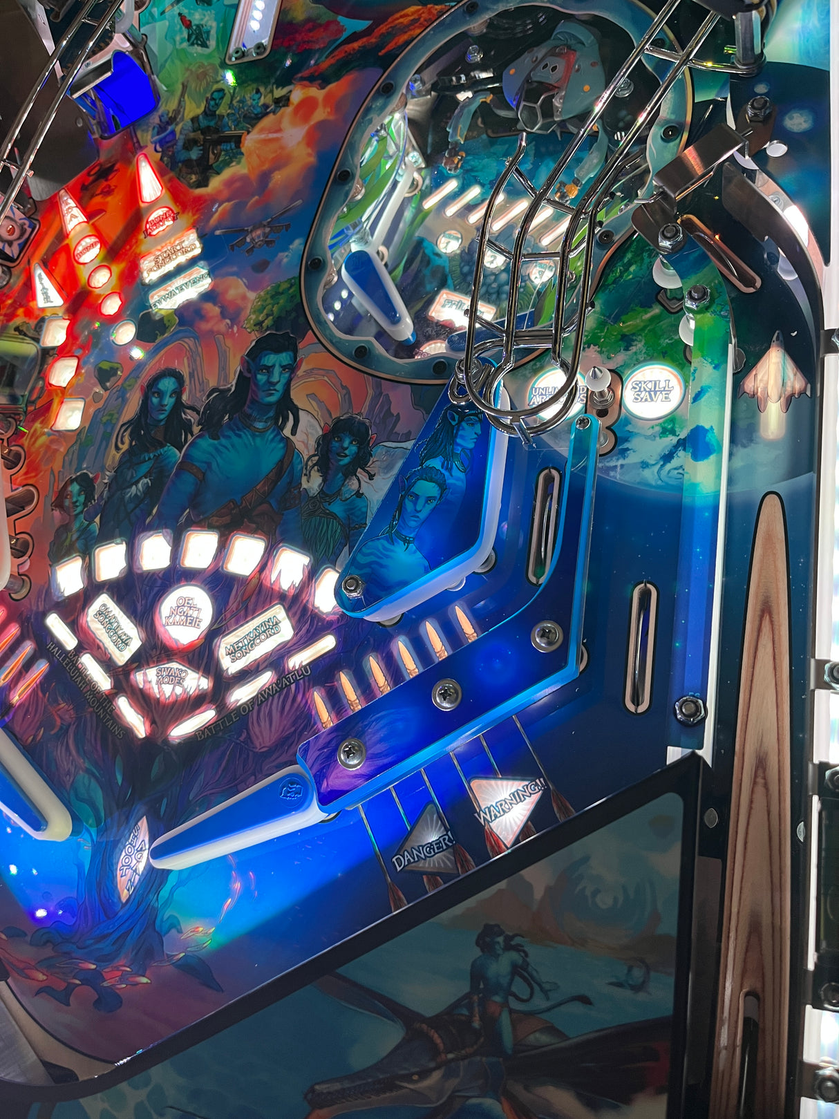Close-up of a colorful pinball machine with vibrant graphics and lights.