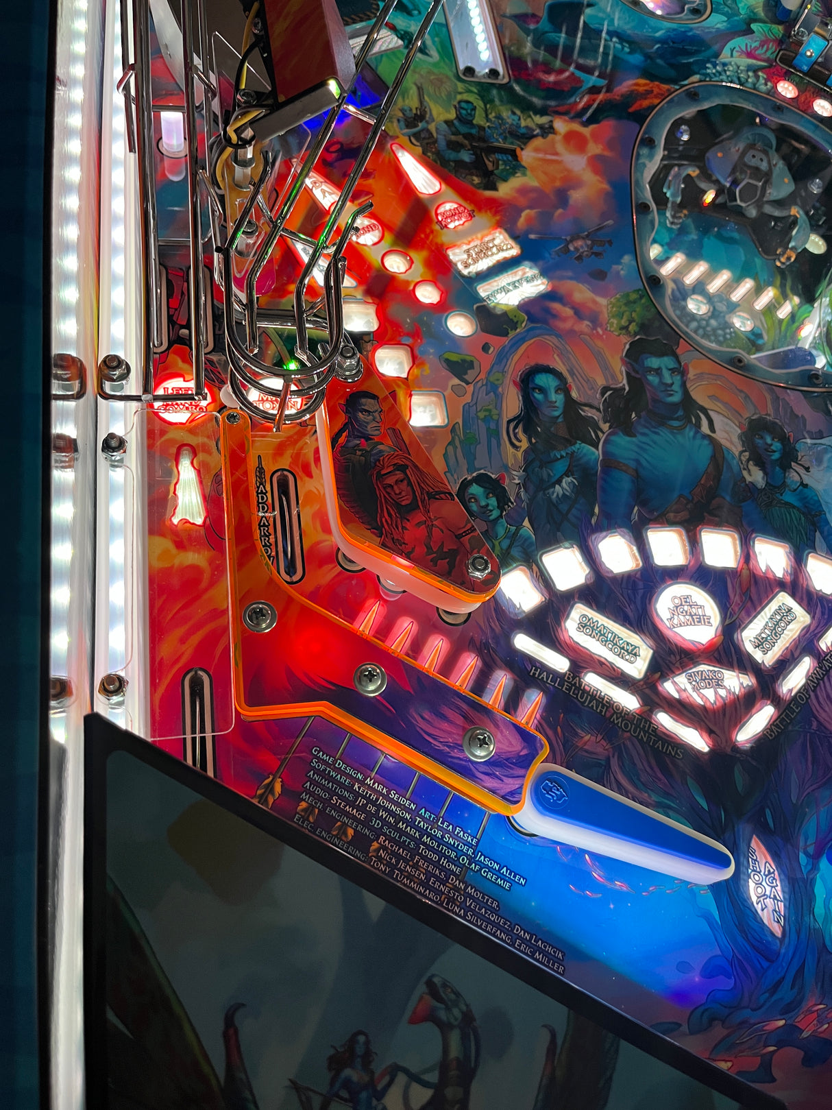 Close-up of a colorful pinball machine with vibrant graphics and lights.
