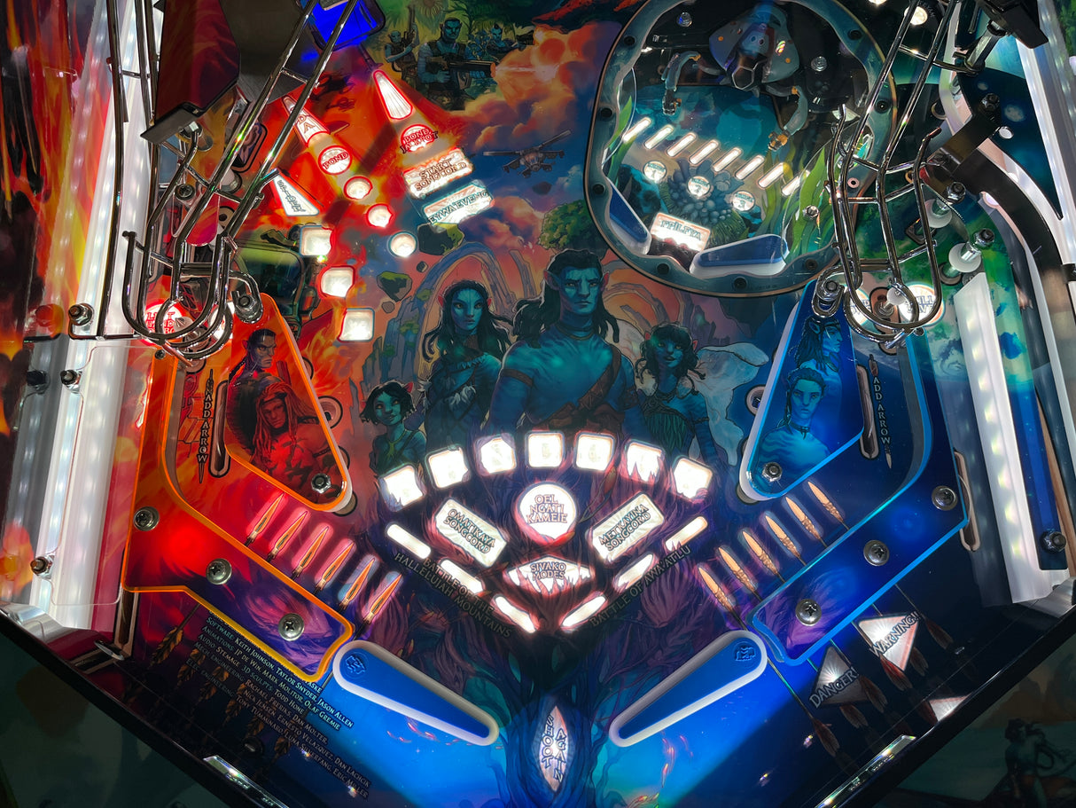 Close-up of a pinball machine with vibrant colors and detailed artwork.