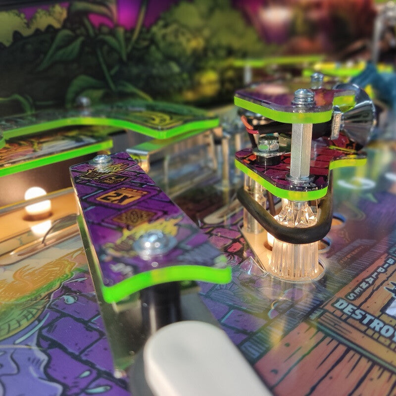 Close-up of a colorful pinball machine with vibrant graphics and mechanical components.