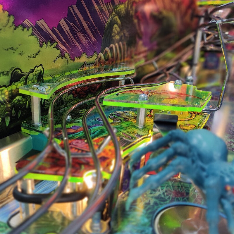 Close-up of a colorful pinball machine with vibrant graphics and mechanical components.