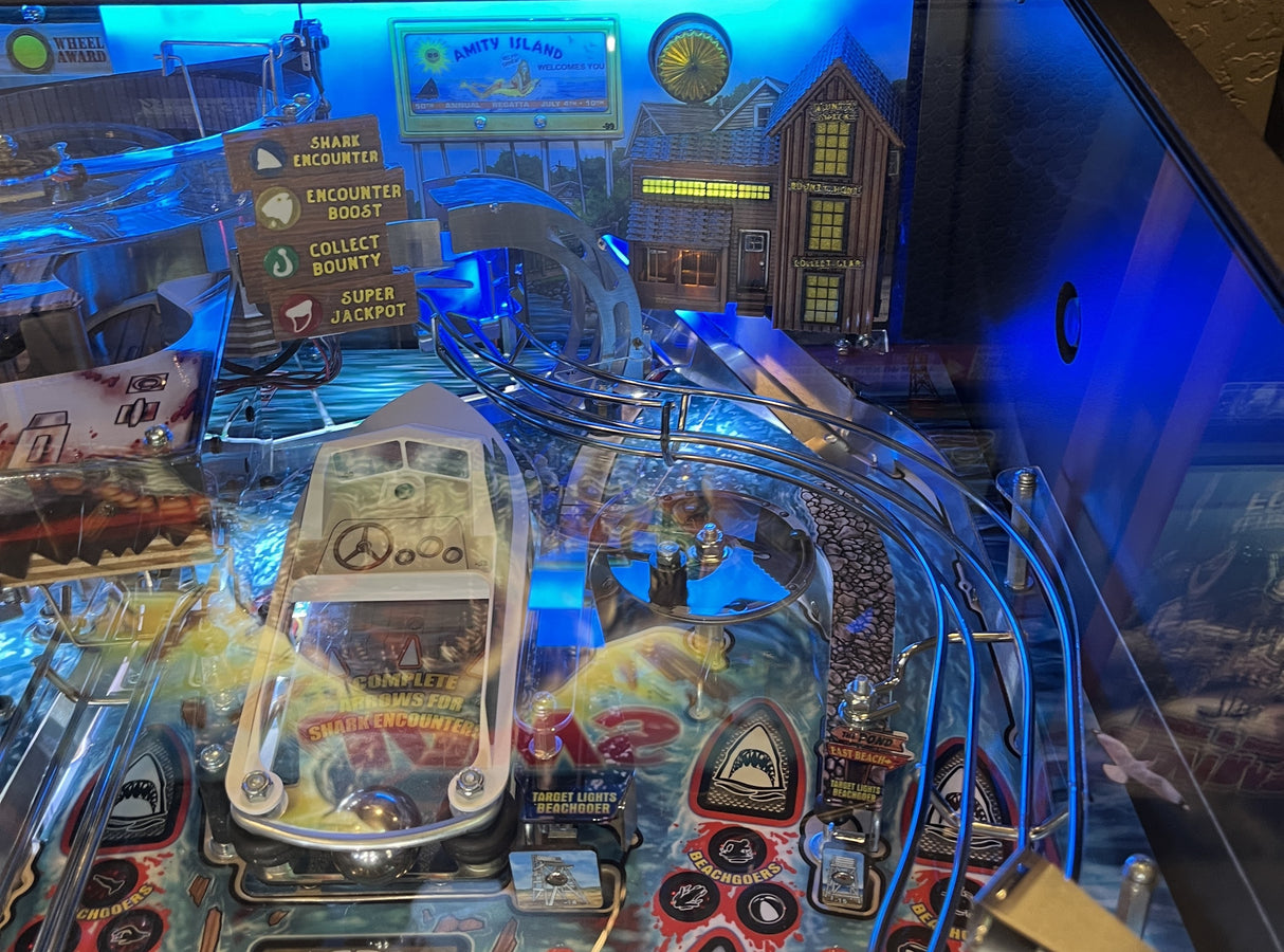 Pinball machine with various components and lights on a dark background