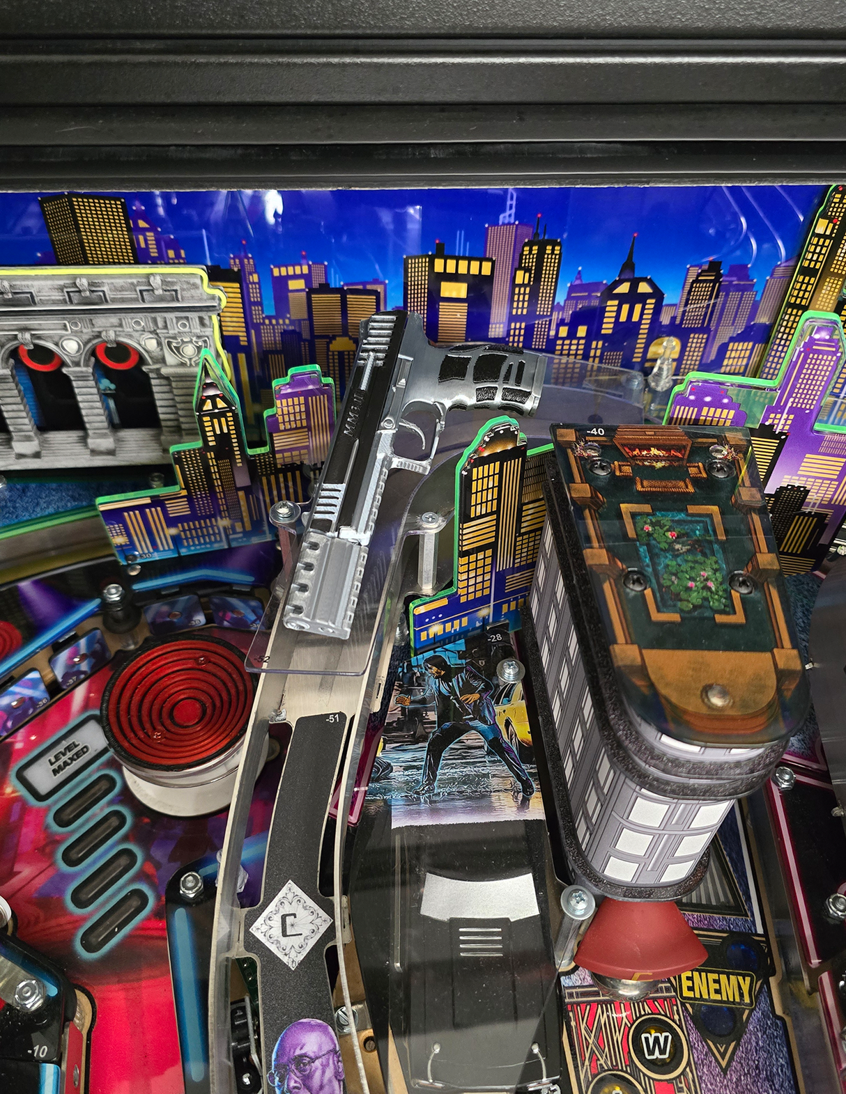 toy gun on pinball machine ramp