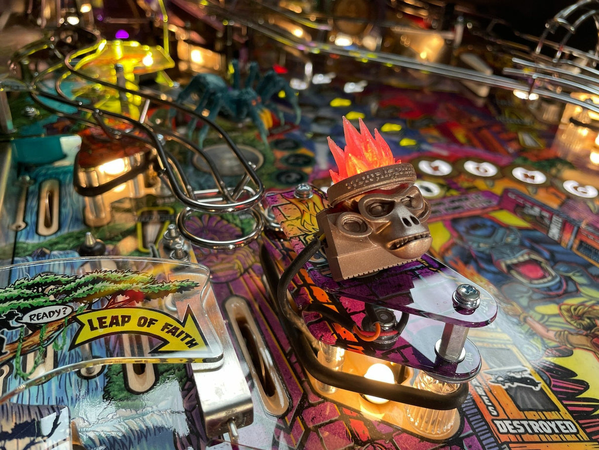 Close-up of a colorful pinball machine with a monkey figure and 'Leap of Faith' label.
