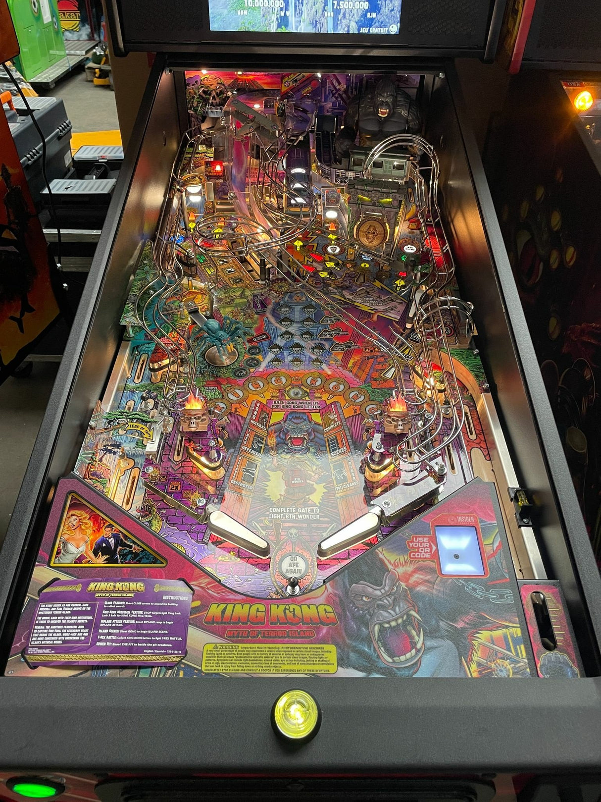 Pinball machine with 'King Kong' theme in an arcade setting