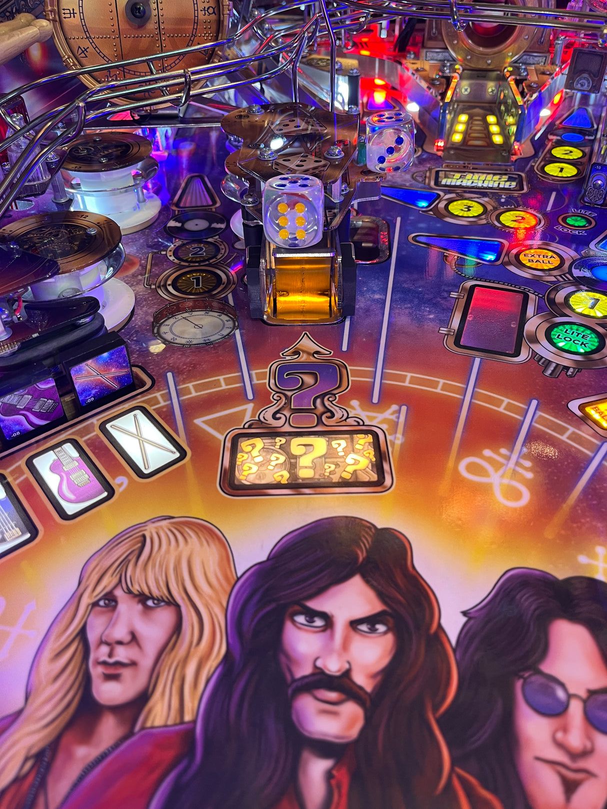 Close-up of a pinball machine with colorful artwork and various playing components.