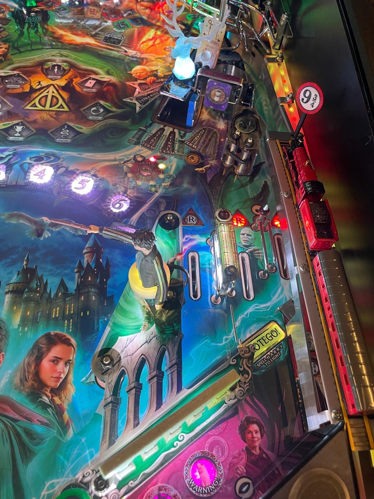 Pinball machine with colorful design featuring characters and scenes from a fantasy movie.