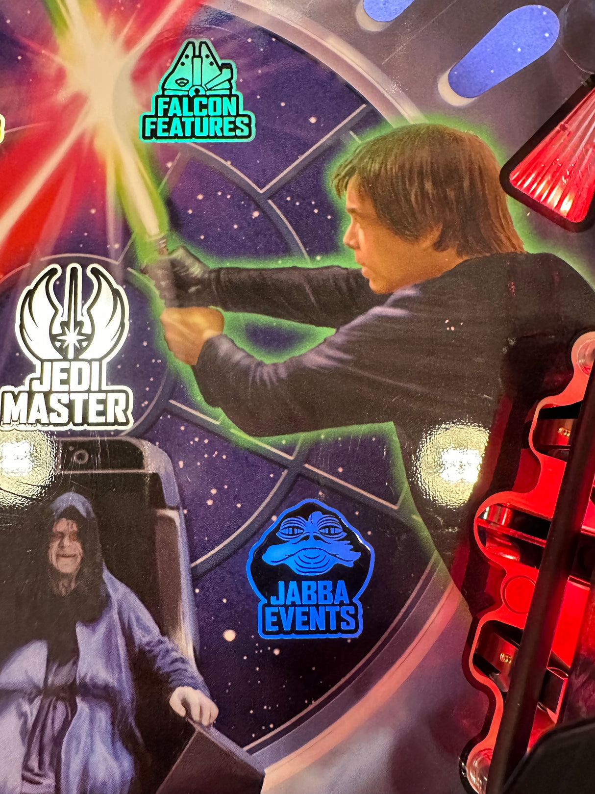 Character holding a lightsaber with promotional logos for Falcon Features, Jedi Master, and Jabba Events.