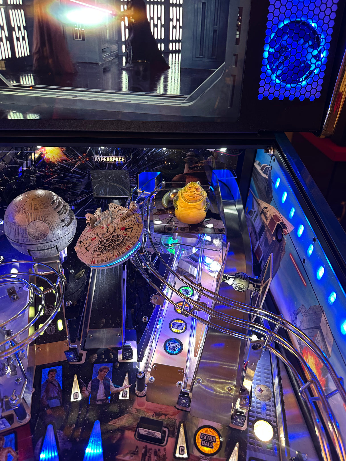 star wars pinball machine playfield and backbox featuring speaker lights, ramp illumination and light up star wars toys