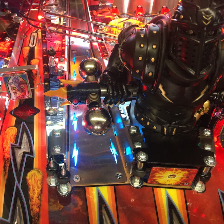 Colorful illumination of pinball machine ramps and elements, featuring a Black Knight figure.