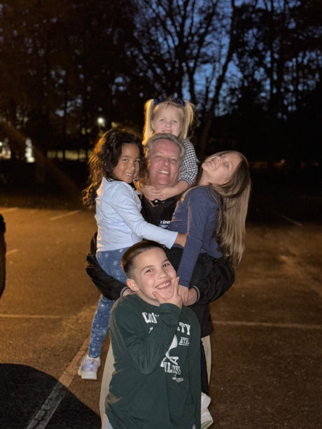 Robert Campbell with his grandchildren in an outdoor setting
