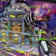 Close-up of a pinball machine with colorful artwork and mechanical components.