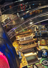 Pinball machine with 'The Bridge' sign and colorful playfield