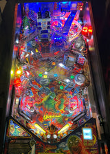 Pinball machine with colorful artwork and glowing lights