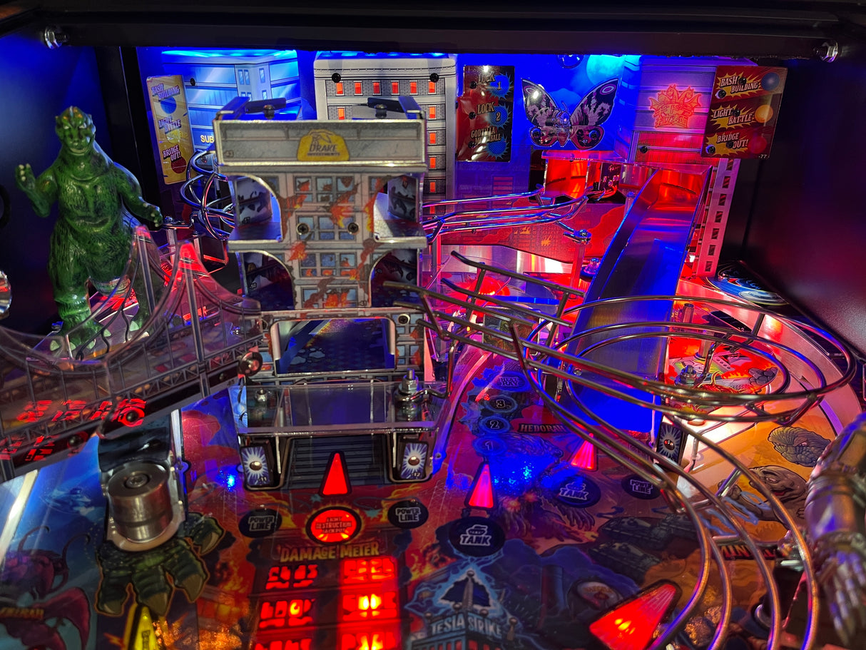 Close-up of a pinball machine with vibrant colors and various components.