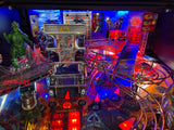 Close-up of a pinball machine with vibrant colors and various components.