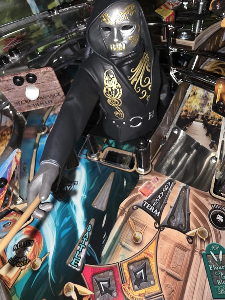 Figurine with a hood and mask on a pinball machine