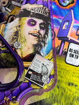 Close-up of installed left slingshot plastic showing Betelgeuse in a GUIDE hat with purple eye sockets.