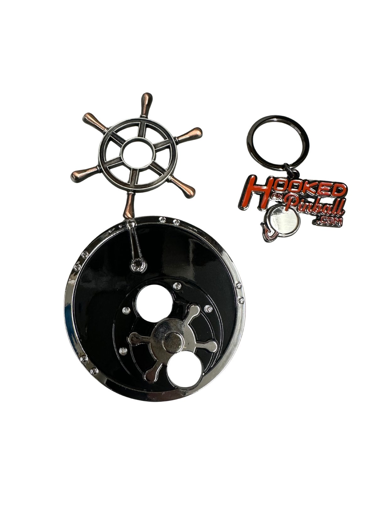 metal toy in shape of ships wheel and reel with a keychain