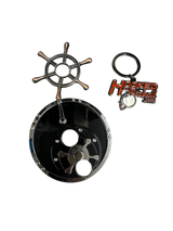 metal toy in shape of ships wheel and reel with a keychain