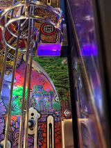Close-up of a pinball machine with colorful artwork and 'Kong's Cave' label.