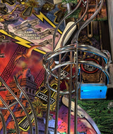 Close-up of a pinball machine with colorful artwork and metal components.