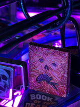 Glowing book with a face design on a dark background