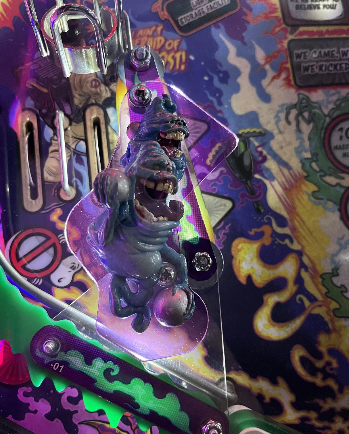 Gorey-style figure on a colorful, detailed pinball machine