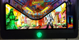 Pinball machine with colorful artwork featuring a green monster and cityscape.
