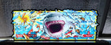 Shark-themed acrylic sign with colorful design on a wooden surface