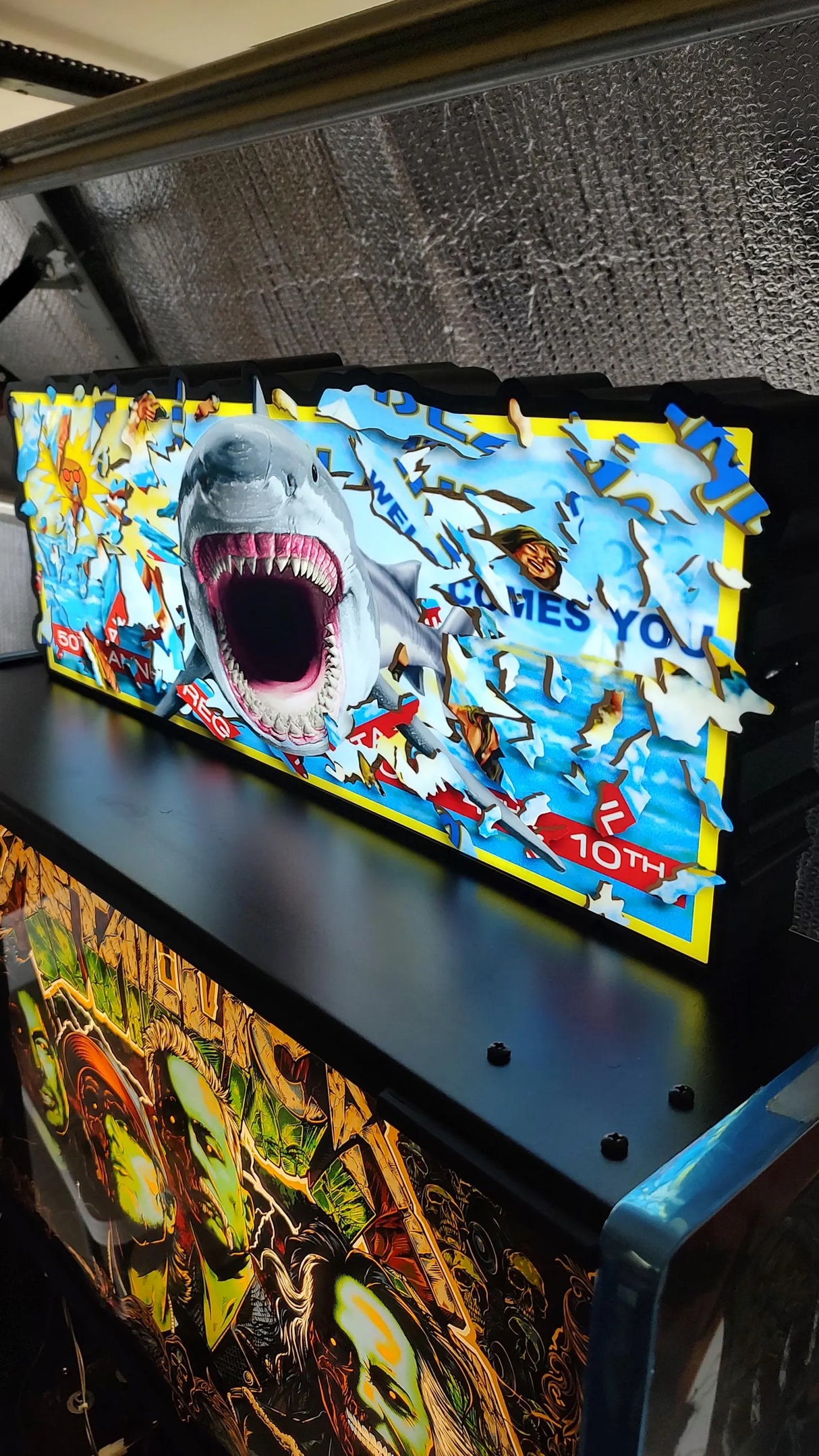 Shark sign on top of a pinball machine