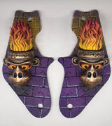 Pair of decorative toys with monkey head designs and flames on a white background