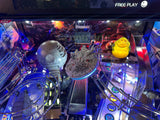 Pinball machine with Star Wars-themed decorations, including a Death Star and Millennium Falcon.